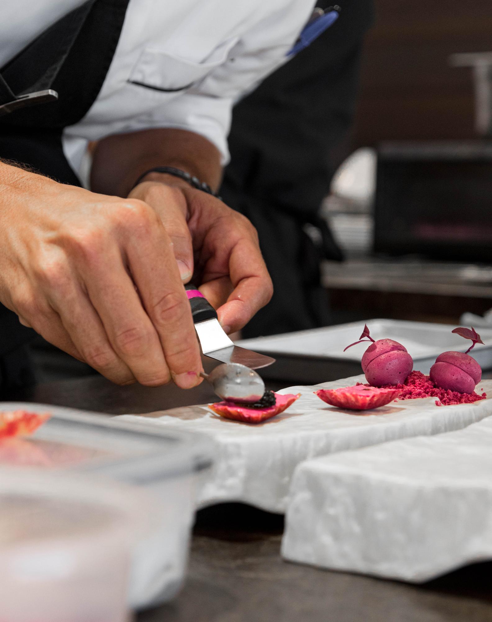 Chef demonstrating knife skill to participant