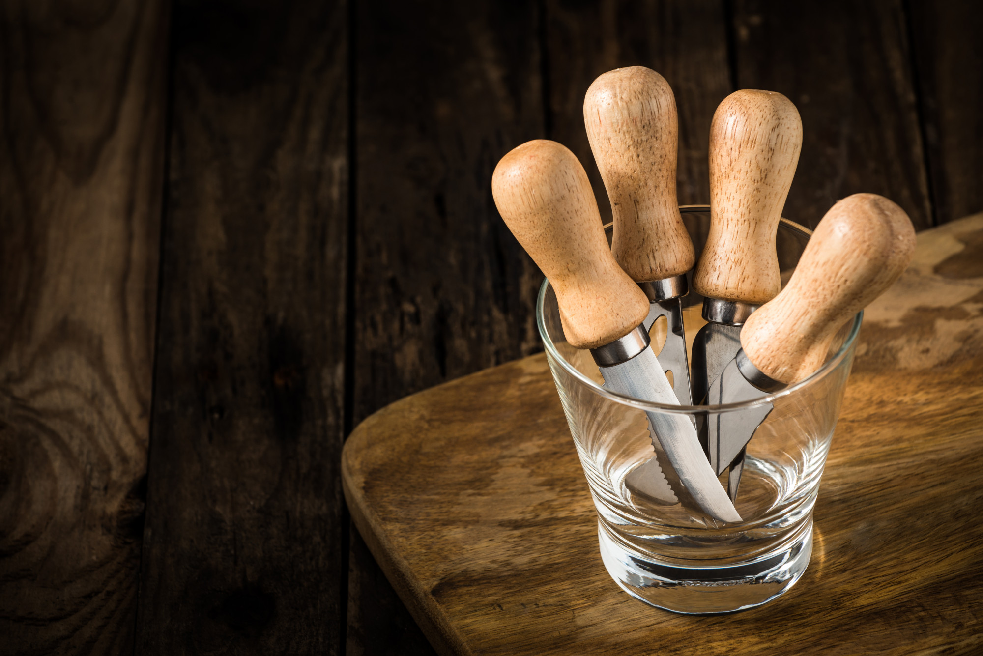 Set of chef tools and tasting spoons on table